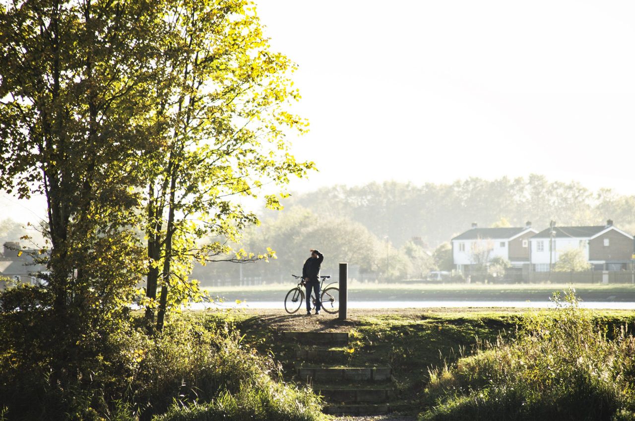 An autumnal view of the newly opened Walthamstow Wetlands in north east London - Europe’s largest urban wetland reserve is free for the public to explore. A man looks at the view from his cycle.