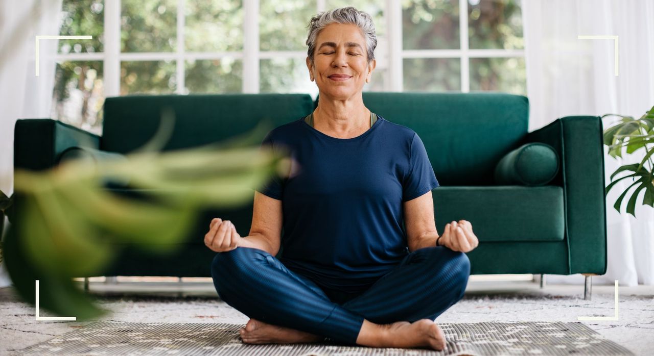 Woman meditating at home, representing one of the New Year&#039;s resolution ideas to try in 2024