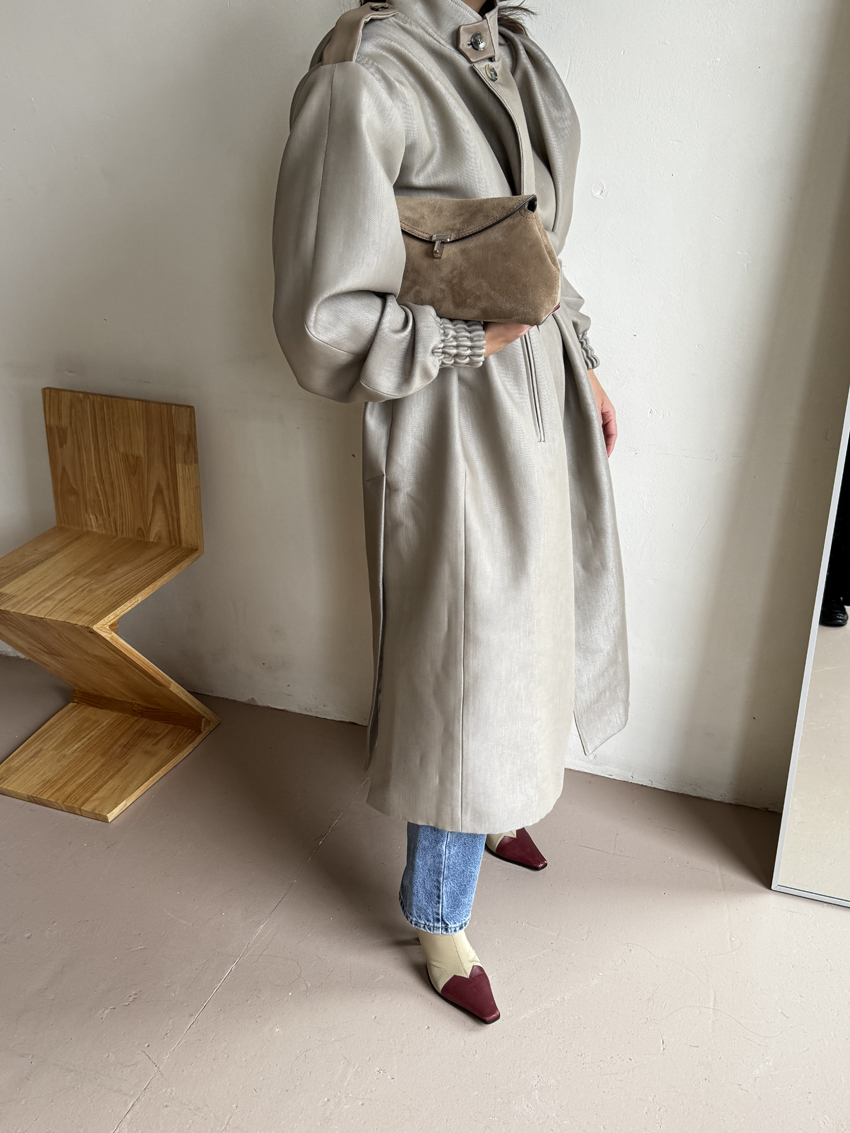 Bettina Looney carrying a Toteme suede T-Lock Clutch.