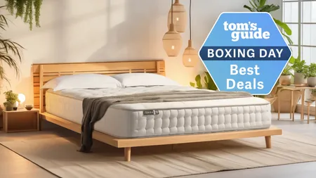 The Simba Earth Escape Mattress on a wooden bed frame in a bedroom. In the top right corner, a Tom's Guide Boxing Day Best Deals graphic.