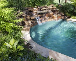pool grotto with planting and waterfall