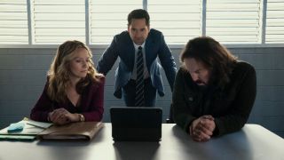 (L to R) Becki Newton as Lorna Crane, Manuel Garcia-Rulfo as Mickey Haller, Angus Sampson as Denis "Cisco" Wojciechowski looking at a computer in The Lincoln Lawyer. 