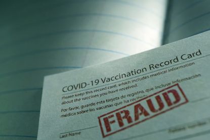 COVID-19 vaccine card stamped with the word "Fraud"