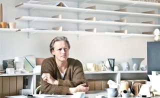 Aldo Bakker sitting at desk in his studio