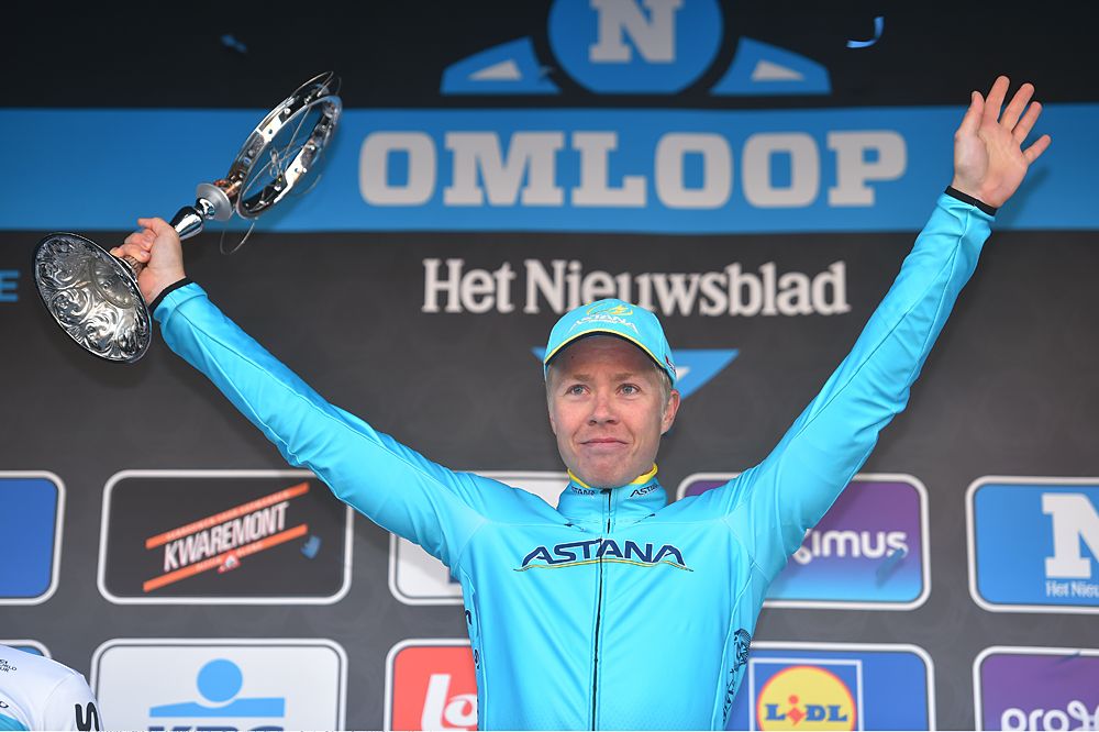 Michael Valgren on the podium as the winner of Omloop Het Nieuwsblad Elite