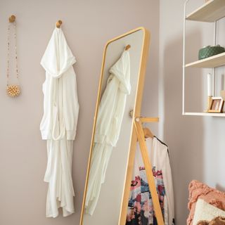 bedroom with dressing gown hanging on hook and mirror