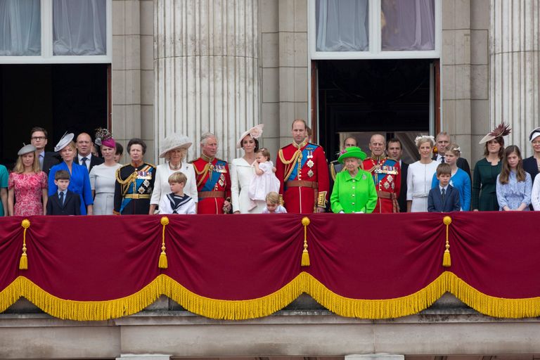 Members of the Royal family and guests including (L-R) Mike Tindall, Zara Philips, Britain's Princess Anne, Princess Royal, Britain's Camilla, Duchess of Cornwall, Britain's Prince Charles, Prince of Wales, Britain's Catherine, Duchess of Cambridge holding her daughter Princess Charlotte, Prince George, Britain's Prince William, Duke of Cambridge, Britain's Queen Elizabeth II and Prince Philip, Duke of Edinburgh stand on the balcony of Buckingham Palace.