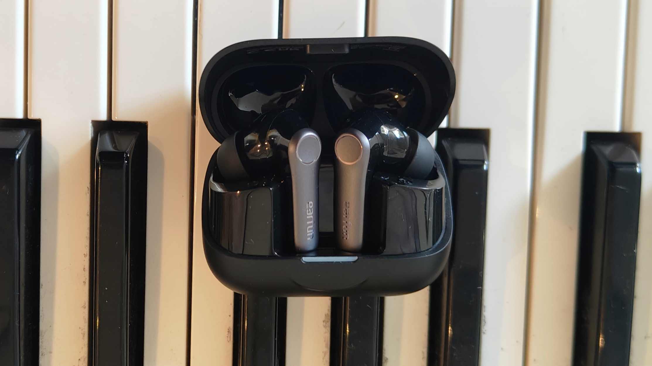 The Earfun Air Pro 4 Plus on top of a keyboard.