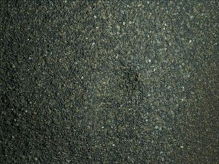 The Mars Hand Lens Imager (MAHLI) camera on the robotic arm of NASA's Curiosity Mars rover used electric lights at night on Jan. 22, 2016, to illuminate this postage-stamp-size view of Martian sand grains dumped on the ground after sorting with a sieve.