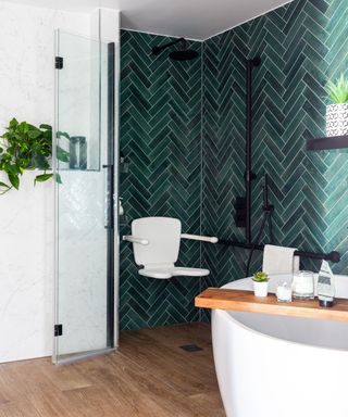 Accessible bathroom with walk in shower featuring green subway tiles and black matt hardware