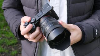 Sony A7CR camera held in a pair of hands