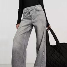 A woman in jeans with a handbag from ASOS.