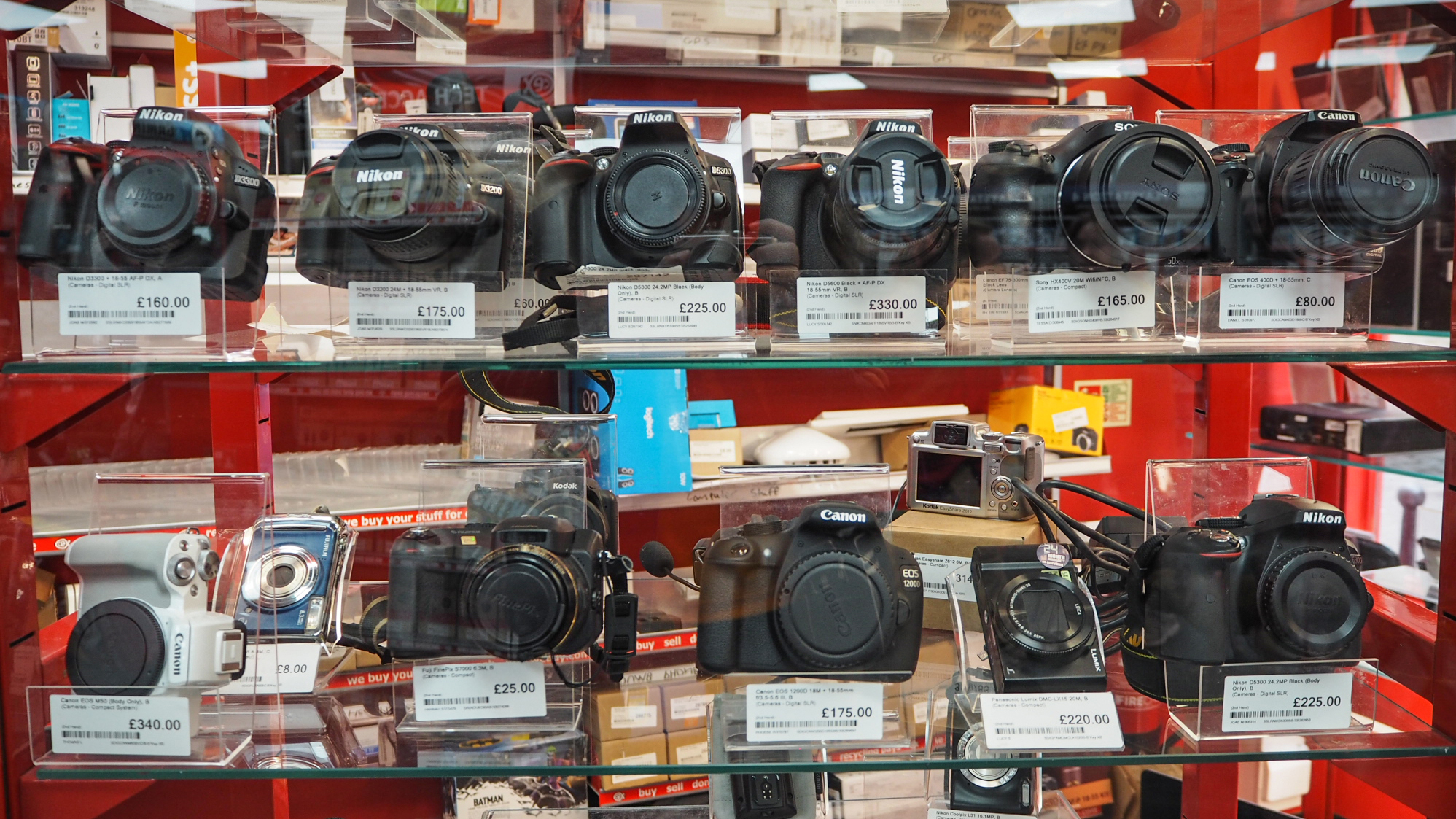 Shelves of used cameras on display at a CEX store in the UK