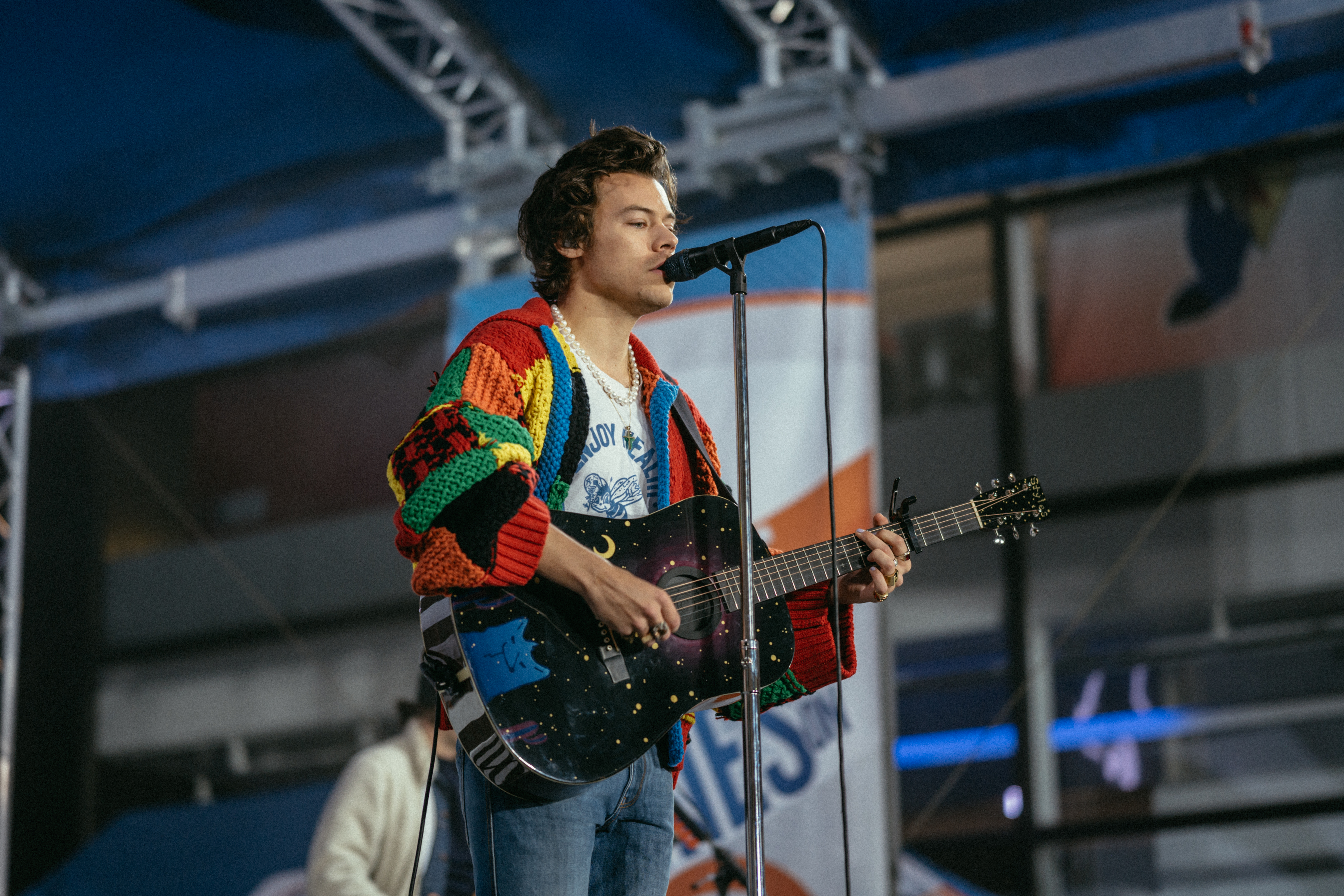 Harry Styles in a colourful patchwork cardigan