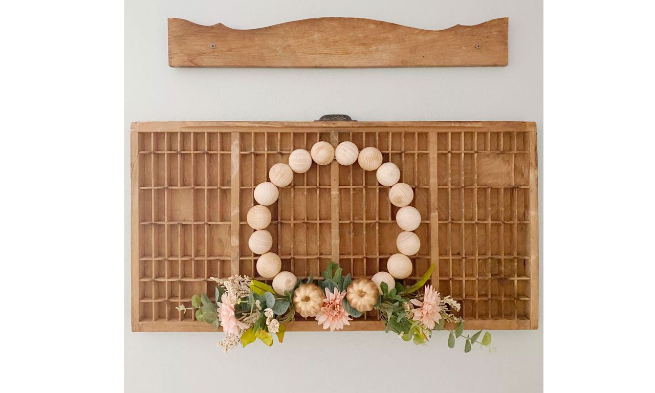 DIY wood split bead wreath hanging off wooden shelving