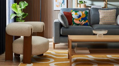 A living room with a light blue sofa and a cream boucle accent chair