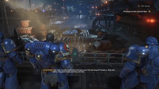 Screenshot from Warhammer 40,000 Space Marine 2 showing an Ultramarine on the Battle Barge inspecting other units