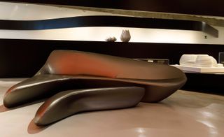 Branded products on display in the exhibition such as a bench Hadid designed for Cassina are icons of 21st-century futurism