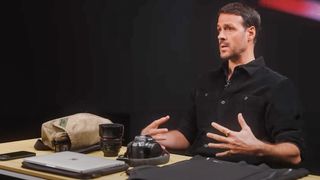 War photographer Jonathan Alpeyrie talking with his Canon EOS R camera on the table in front of him