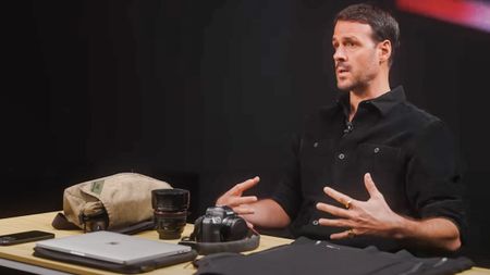 War photographer Jonathan Alpeyrie talking with his Canon EOS R camera on the table in front of him