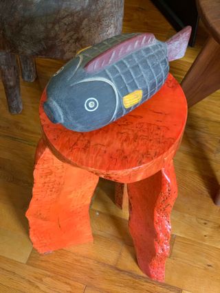 Fish carving on red stool at Stephen Burks’ home
