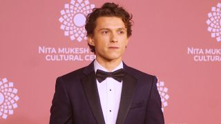 Tom Holland in a black tux and looking a little bit like James Bond at India event in 2023.