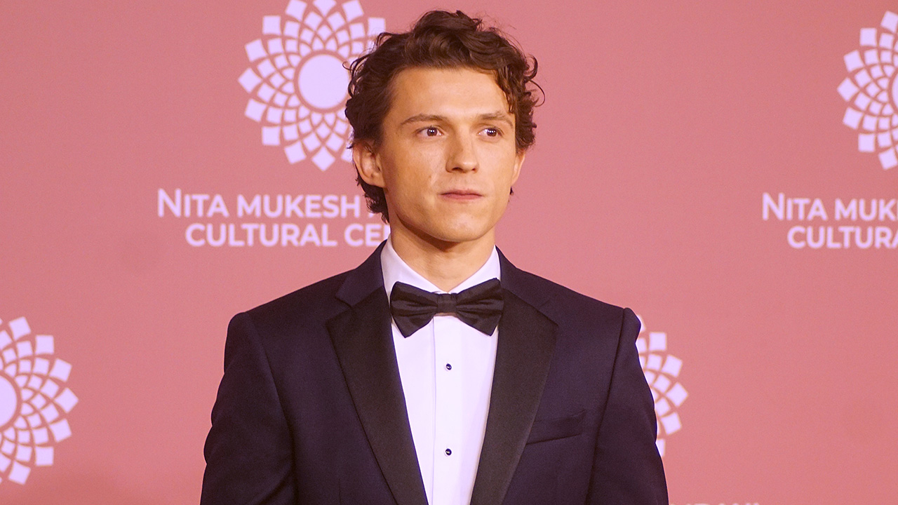 Tom Holland in a black tux and looking a little bit like James Bond at India event in 2023. 