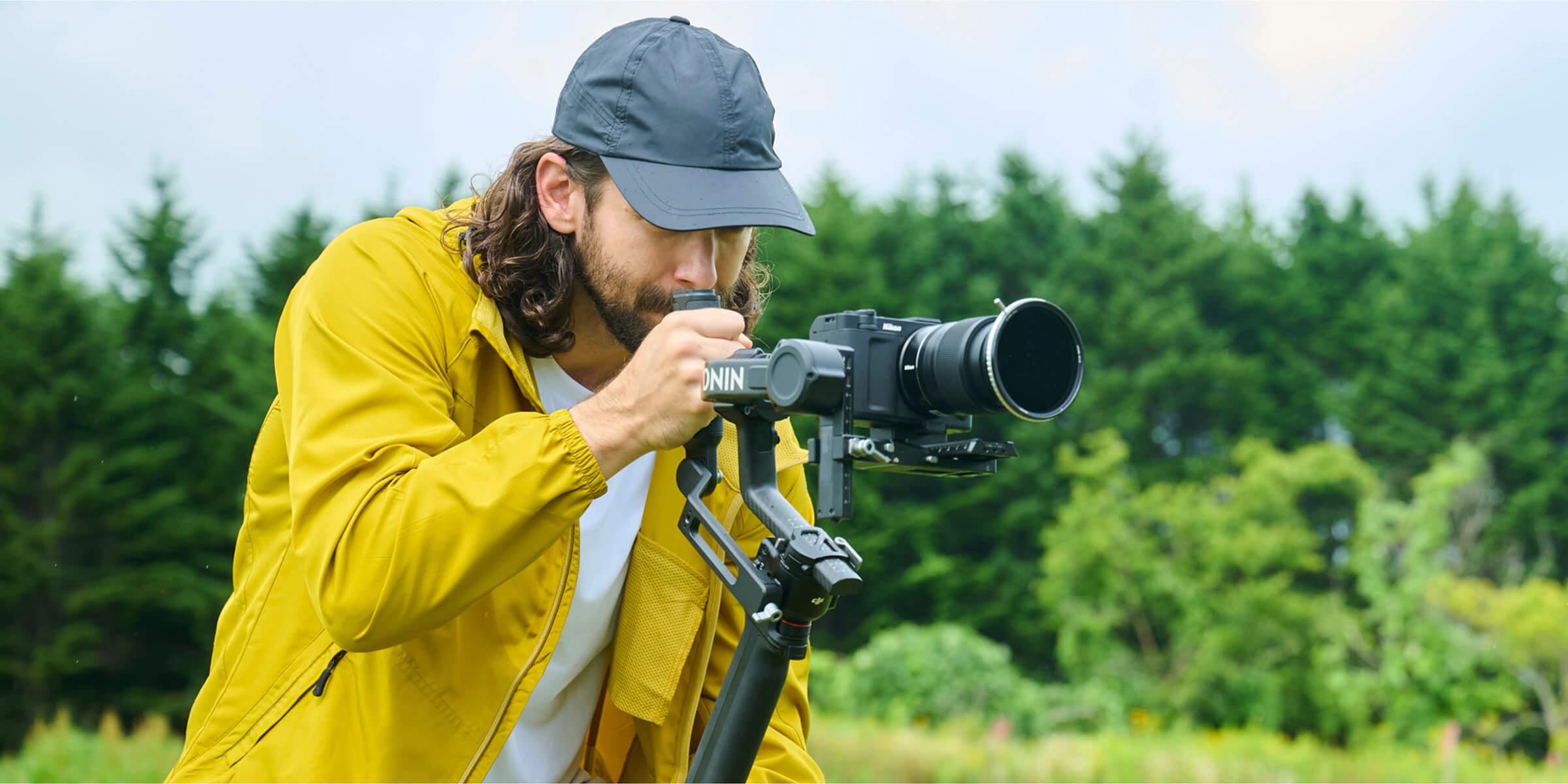 Nikon&#039;s first cinema camera, the Nikon ZR, being used outdoors by a young men near a woods on a gimble