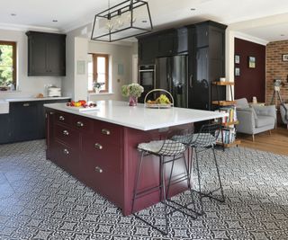 blue and dark red kitchen with black and white patterned floor tiles and open plan living area