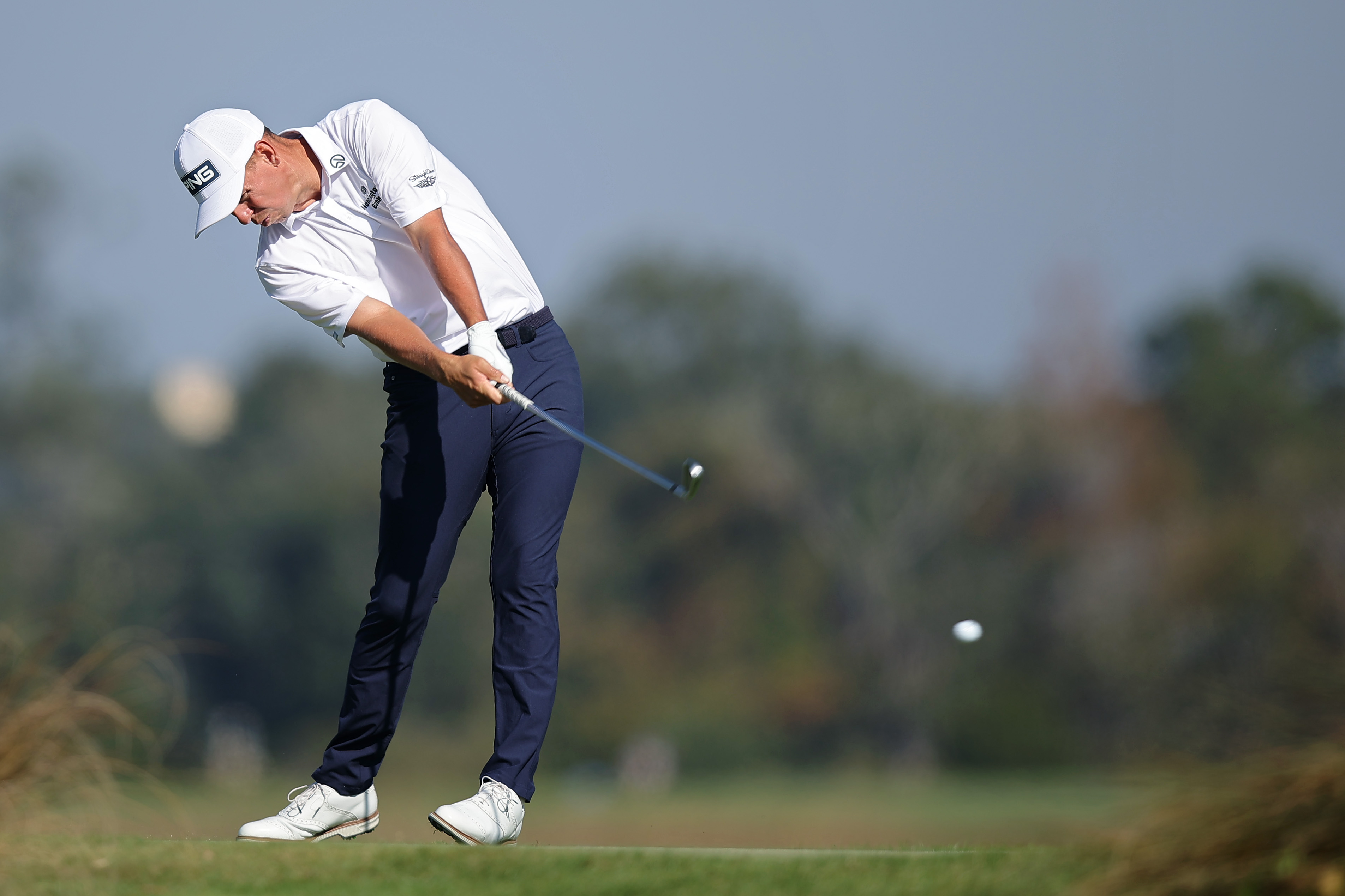 Sam Stevens hits an iron shot