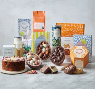 The contents of the Ultimate Easter Hamper by London bakery Cutter & Squidge including a Simnel cake, cookies, brownies and chocolate eggs