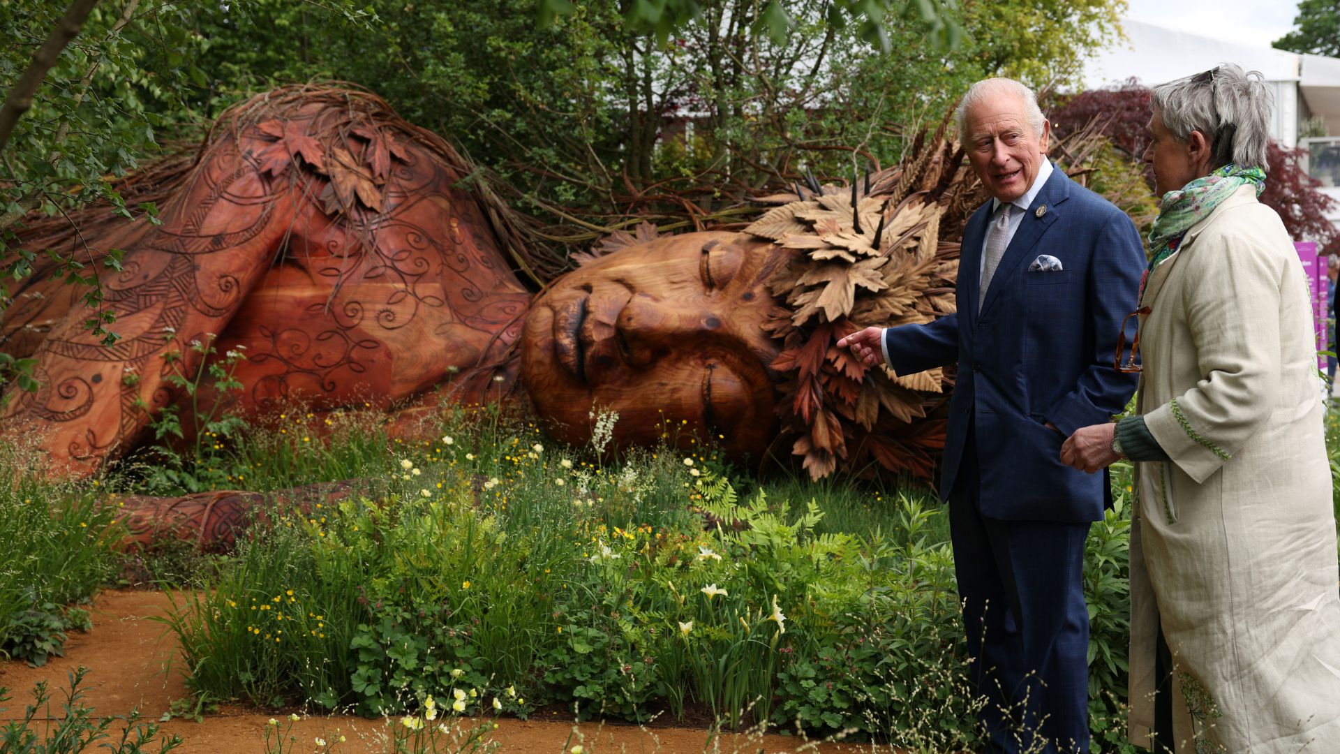 picture of King Charles and Sara Eberle in the show garden with Gaia sculpture