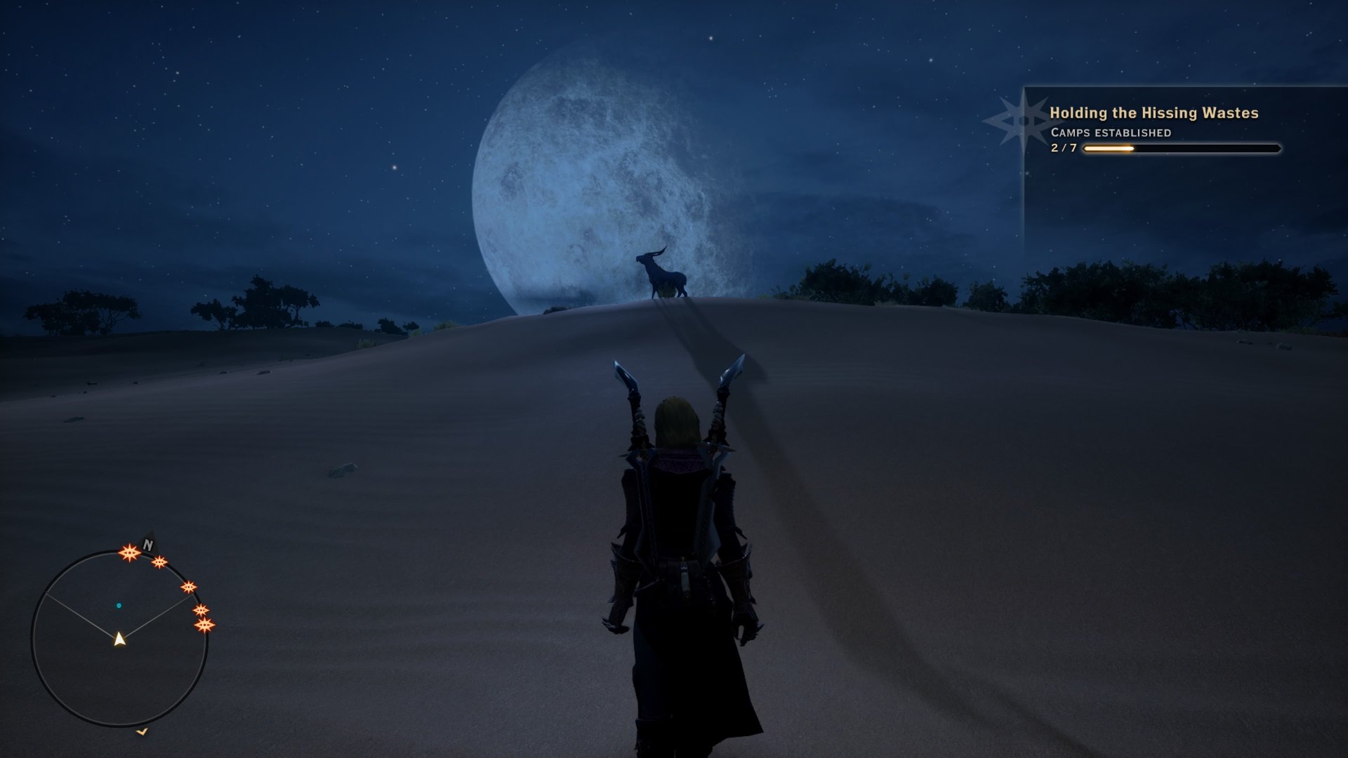 Dragon Age: Inquisition screenshot of a rogue inquisitor in the Hissing Wastes looking out over the horizon, and a large moon can be seen hanging in the sky