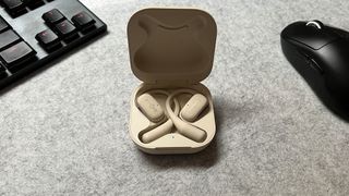 The Shokz OpenFit in their charging case