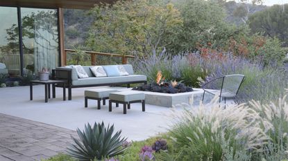 contemporary patio with built in firepit and dry planting scheme