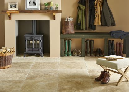 Stone Floor in hallway with fireplace and boot store