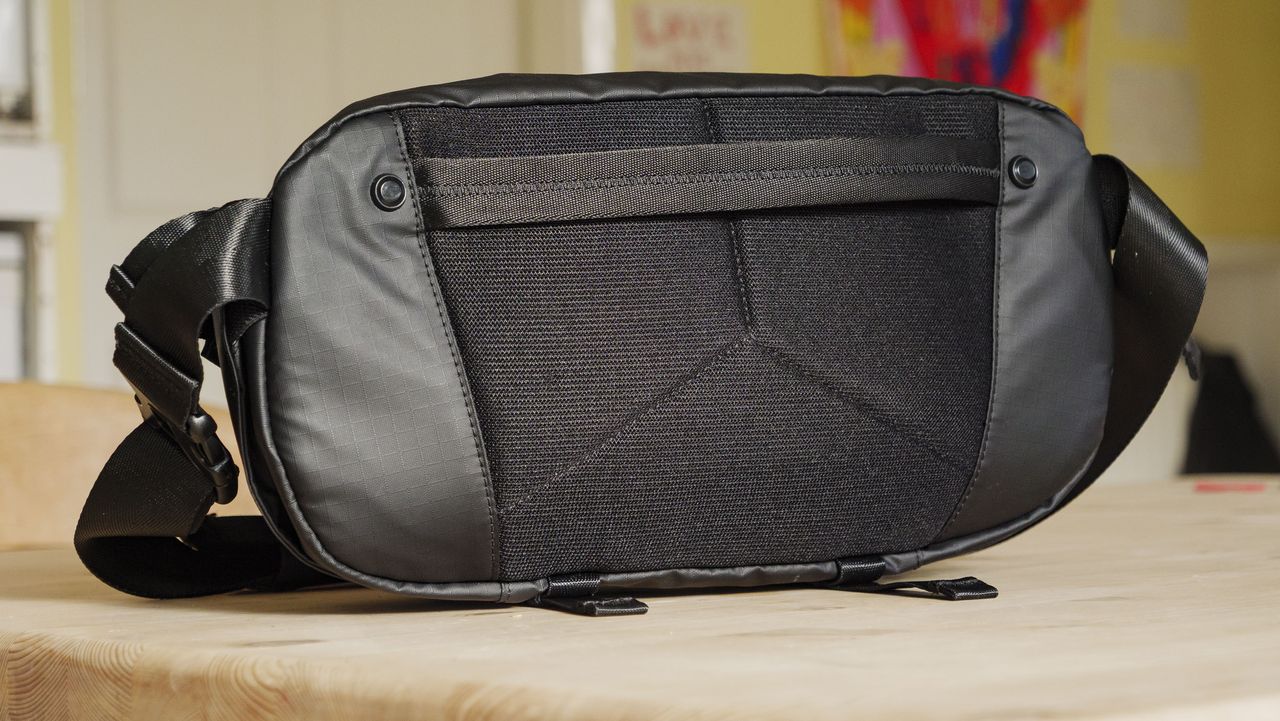 The Ulanzi Camera Sling Bag on a wooden table, back