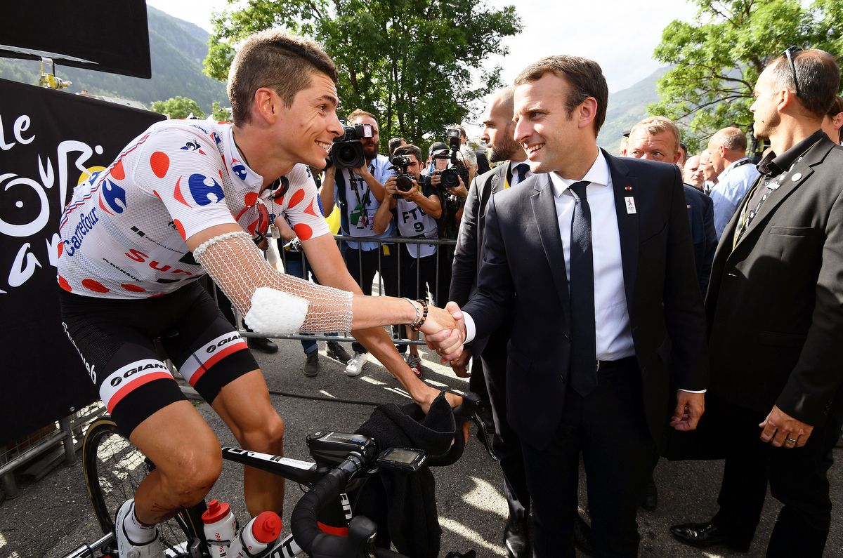 Warren Barguil shakes the hand of French president Emmanuel Macron as he warms down