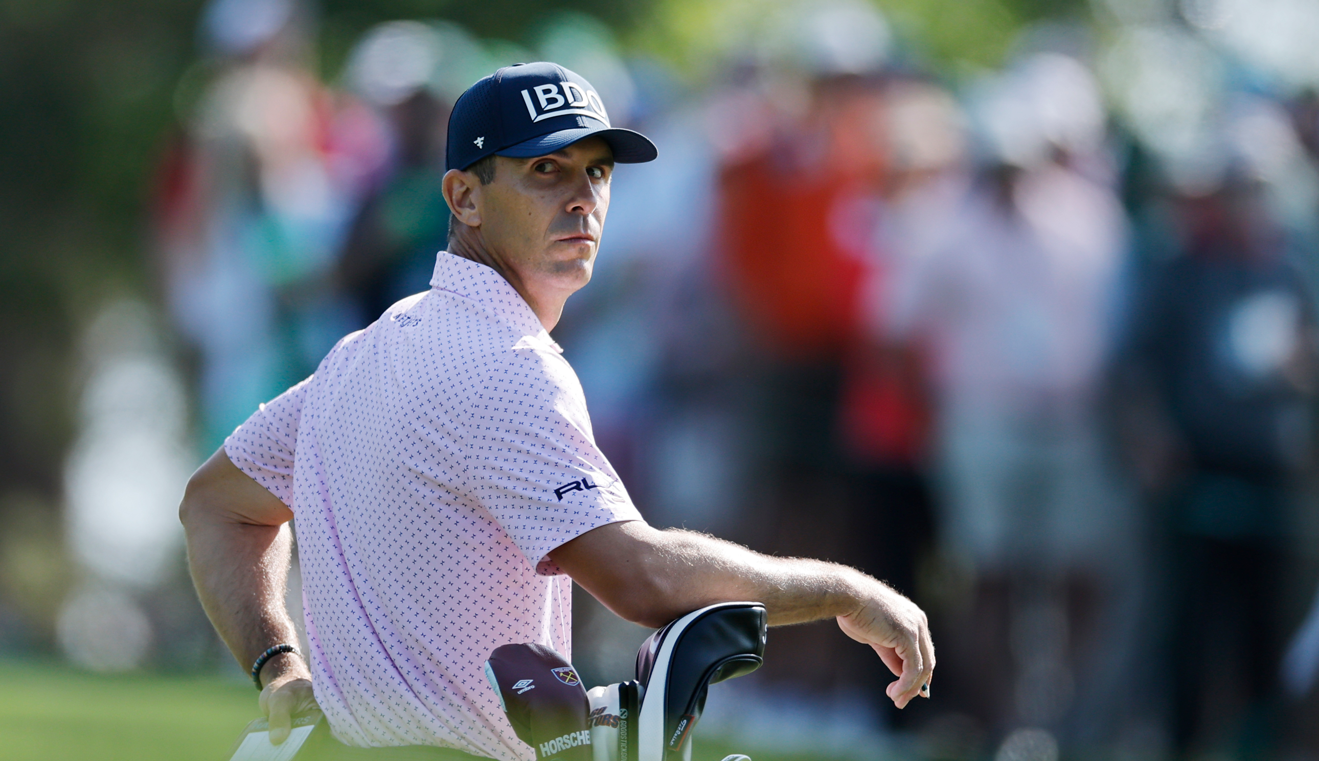 Billy Horschel stares on whilst stood next to his golf bag