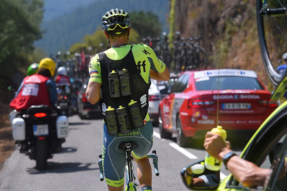 A Tinkoff riders uses a backpack to carry water to his teammates.