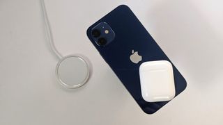 iPhone with AirPods and MagSafe charger