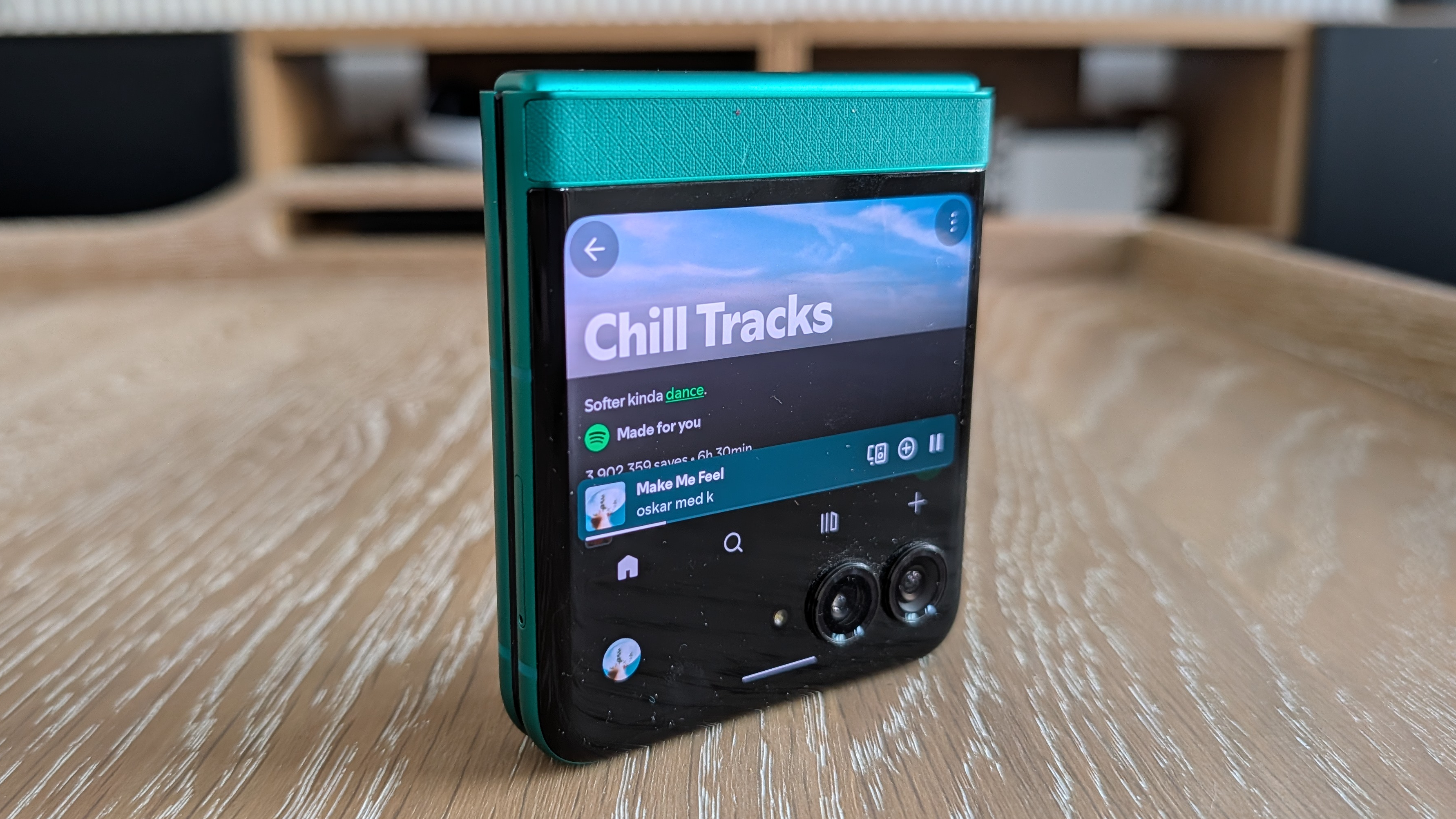 Motorola Razr 2026 in blue, being held in the hand