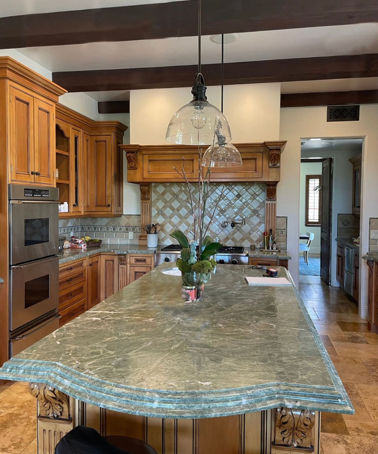 Before the remodel, this kitchen was dated, with orange wood cabinets and oversized features
