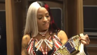 Zelina Vega looks at her United States Championship after winning on SmackDown