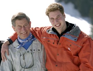 Prince Charles smiling with his teenage son Prince William at the start of their annual skiing holidays