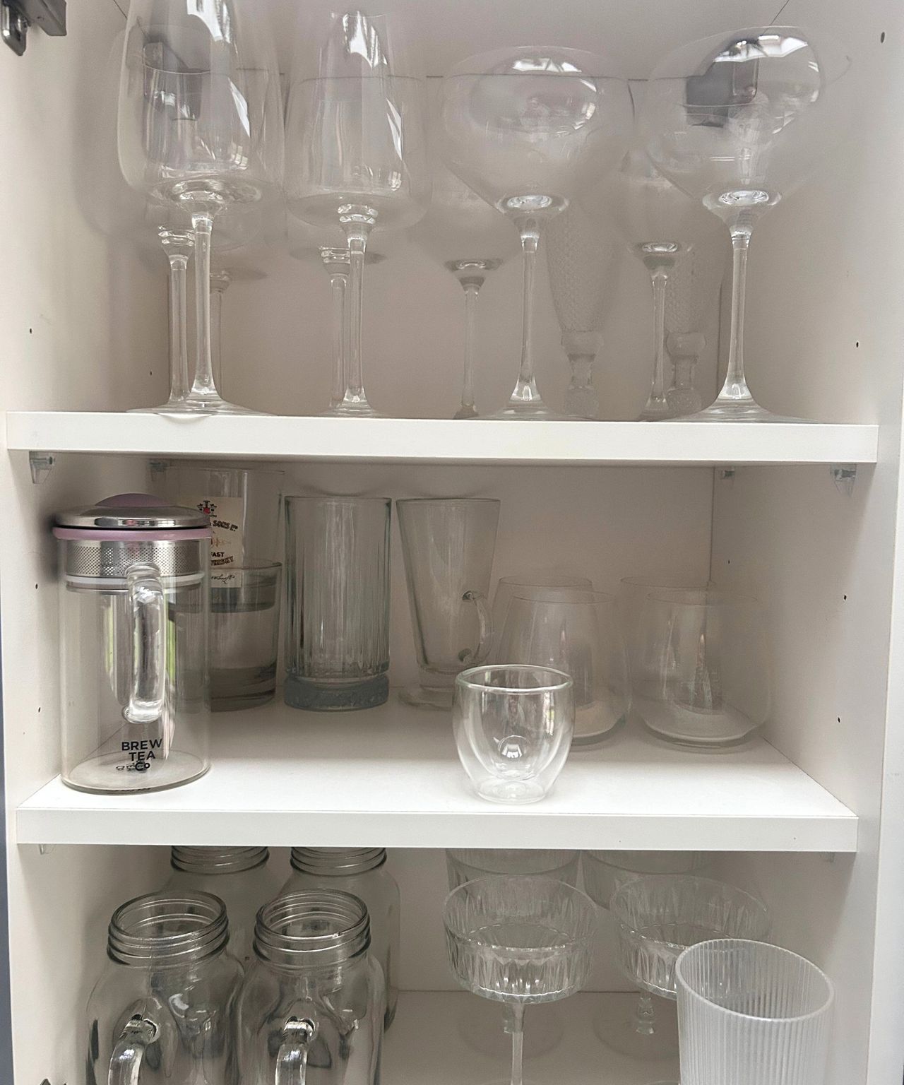 Kitchen cupboard with messy glassware