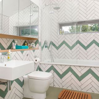 bathroom with white and green tiled pattern