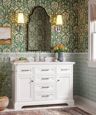 Maximalist, wallpapered bathroom with symmetrical lighting either side of the bathroom vanity mirror