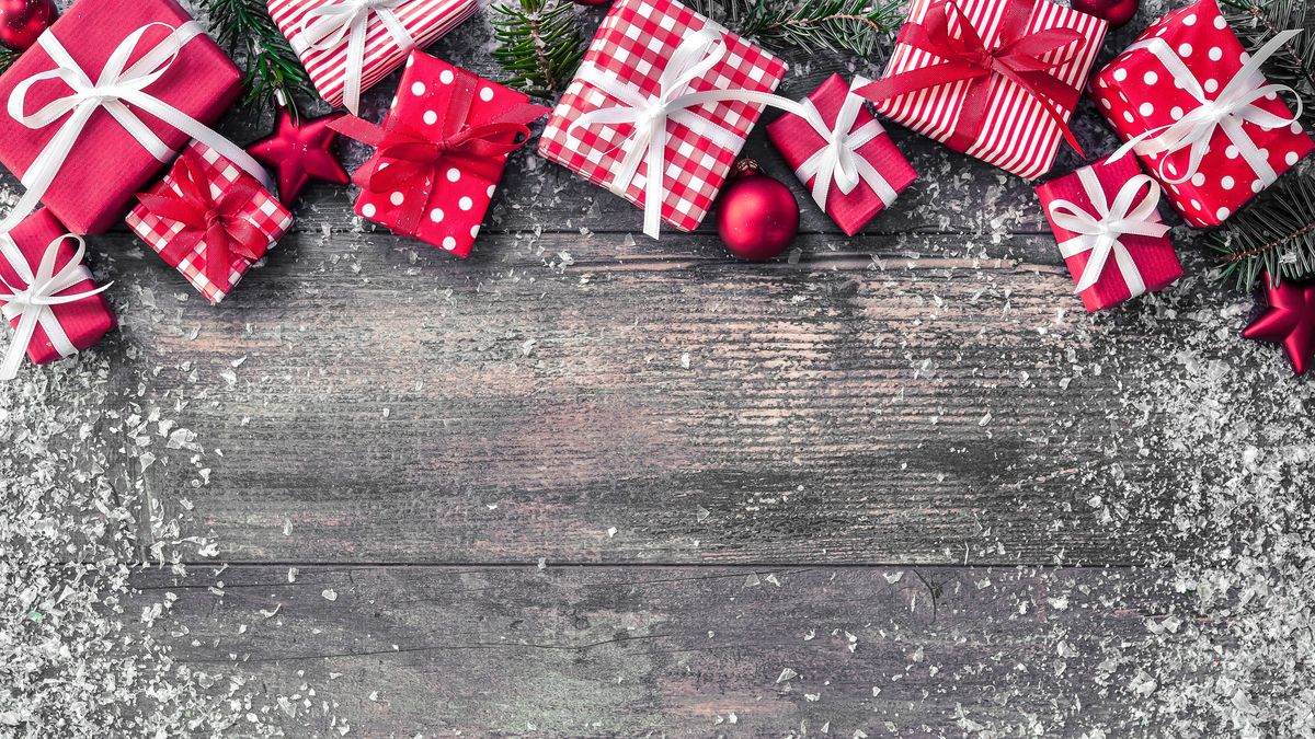 A top-down photo of some wrapped presents on wood