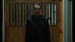 Matthew Rhys as Tom Loflis wearing a raincoat in Widow's Bay